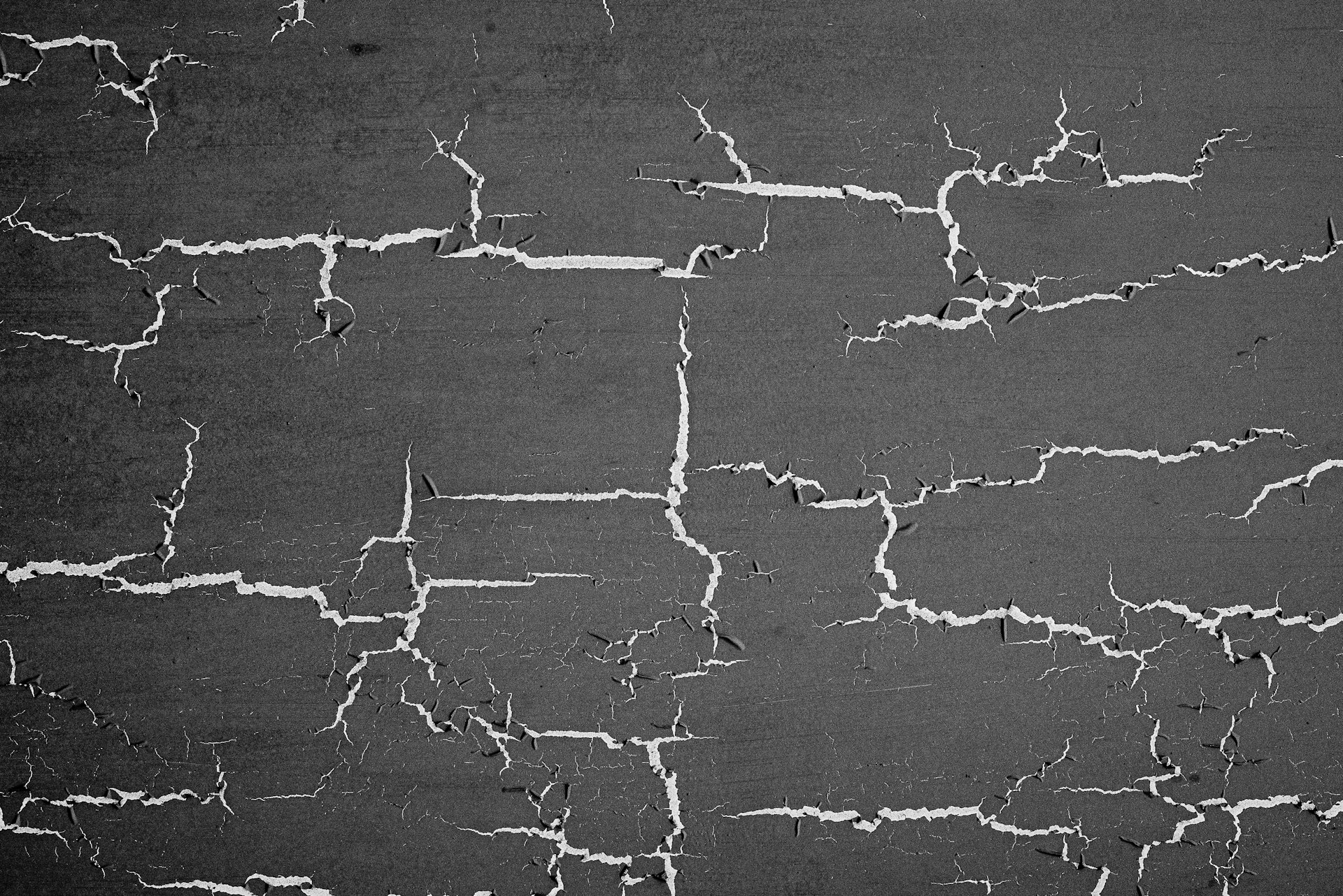 a black and white photo of a cracked wall
