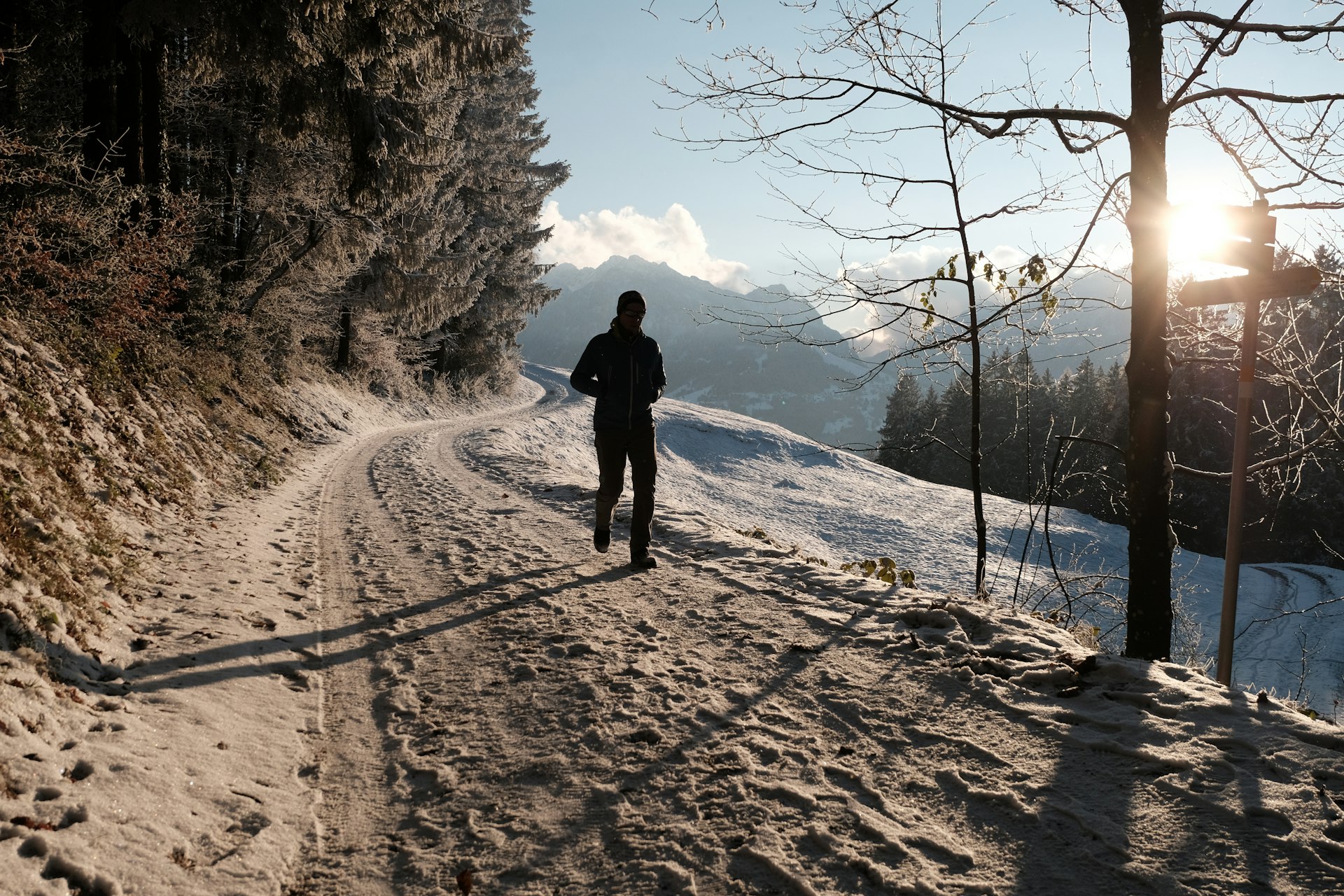 a person walking down a snow covered road